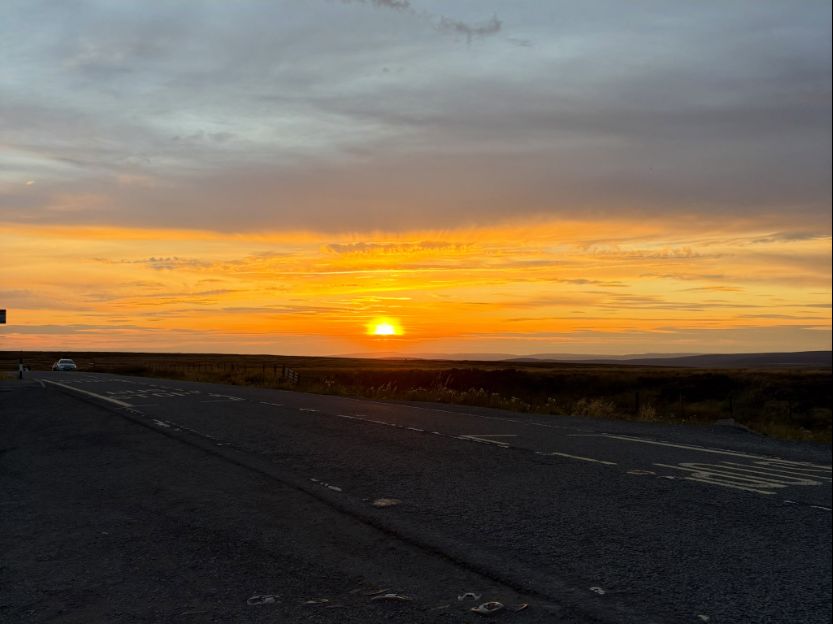 Sunset over the Peak District, the sky turning gold above the moors
